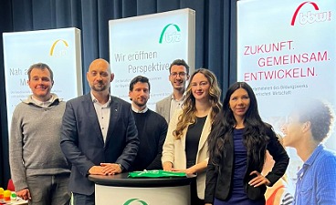 6 Mitarbeiter und Mitarbeiterinnen stehen vor der Messewand