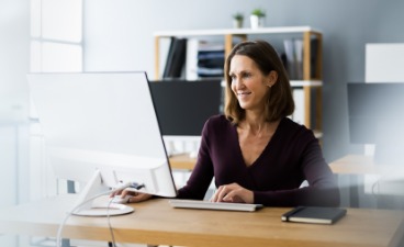News- Bild: Frau sitzt vor einem Computer